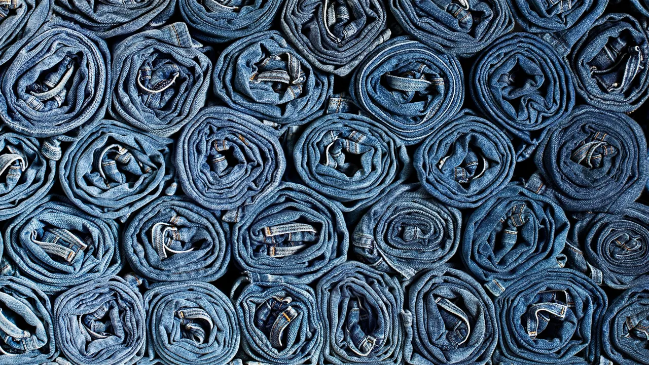 Rolls of finished denim stacked in the warehouse